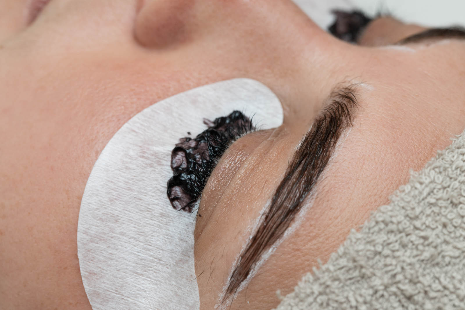 Coloring the eyebrows and eyelashes with henna in a beauty salon, Spa. Professional skincare.